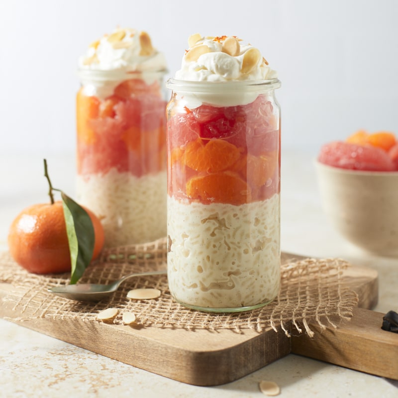 Riz au lait d'amande aux agrumes servi en bocal avec chantilly, clémentines et pamplemousse rose
