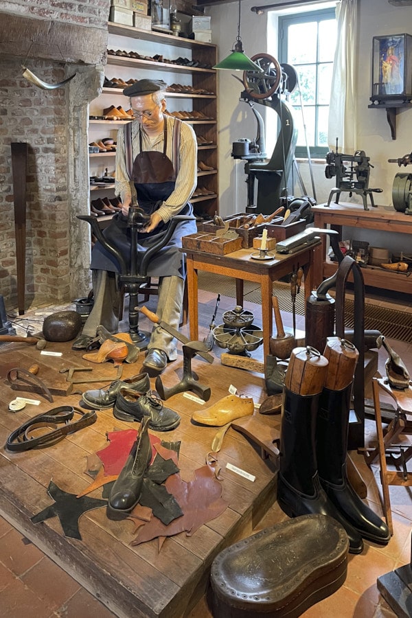 Artisan cordonnier travaillant dans un atelier brugeois